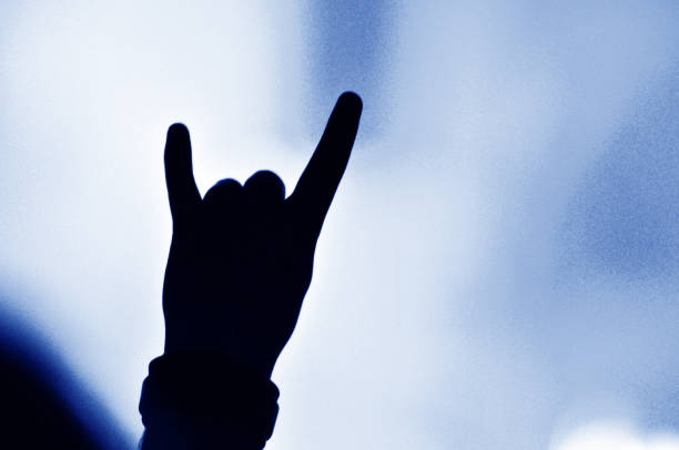 istock Crowd at a music concert, audience raising hands up 1367742687