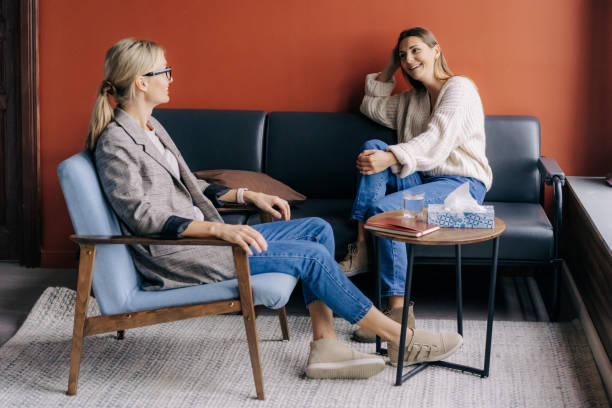 istock Relaxed young woman talking with therapist in a cozy office. 1367748399