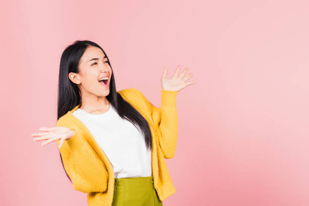 istock woman standing winning and surprised excited screaming 1367748462