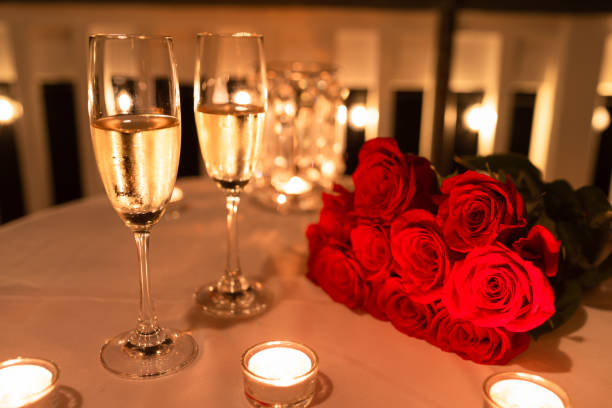 Romantic candlelight dinner setting. Valentine's Day. rose bouquet red table stock pictures, royalty-free photos & images