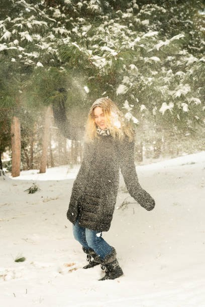 istock Pretty female embracing winter snow 1367749094