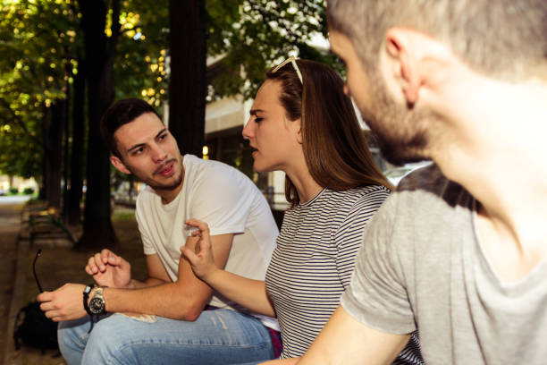 Group of friends enjoying in summer time while sitting on bench