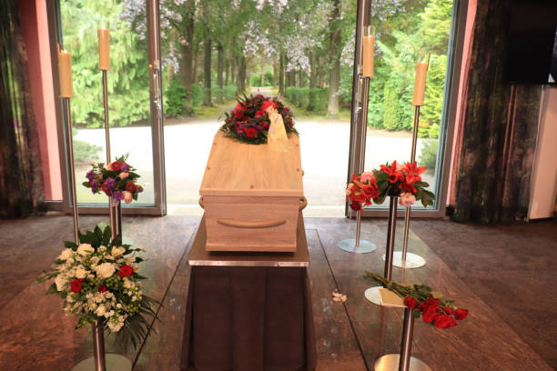 A coffin with a flower arrangement in a morgue stock photo