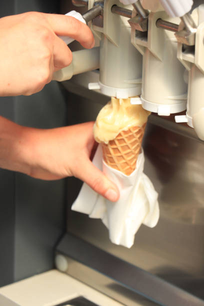 istock Hand holding waffle cone with twisted ice cream 1367750116