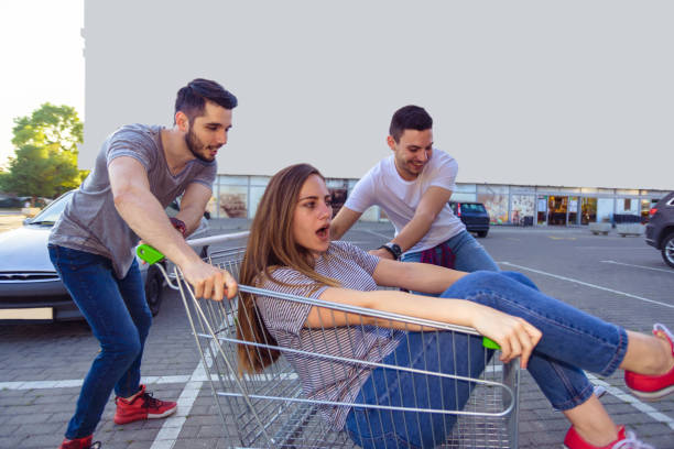 istock Group Of Friends Having Fun With Shopping Trolley 1367750168