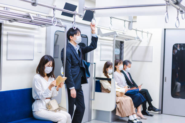 istock People riding the train wearing masks 1367754075