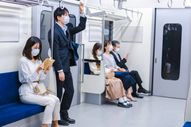 istock People riding the train wearing masks 1367754077