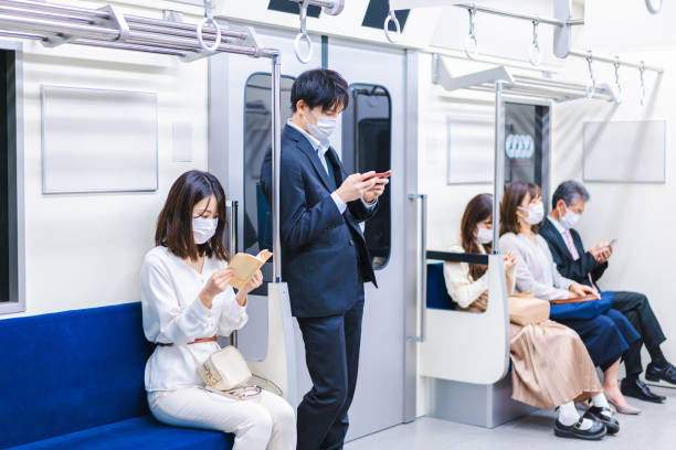 istock People riding the train wearing masks 1367754079