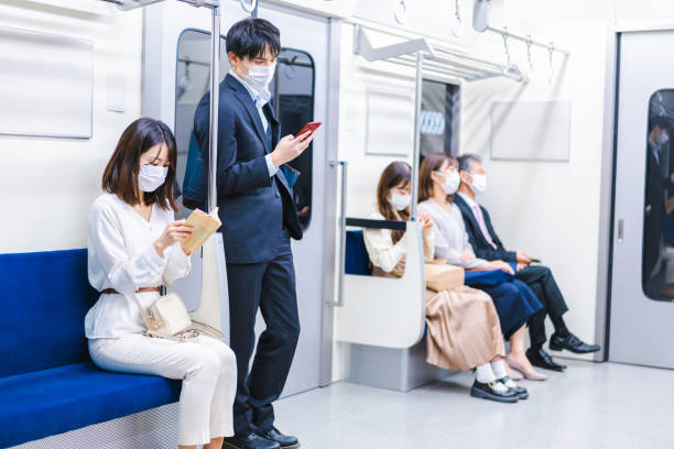 istock People riding the train wearing masks 1367754080