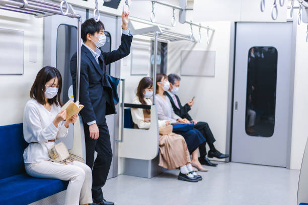istock People riding the train wearing masks 1367754081