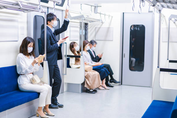 istock People riding the train wearing masks 1367754082