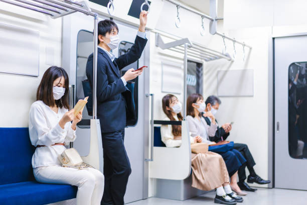 istock People riding the train wearing masks 1367754095