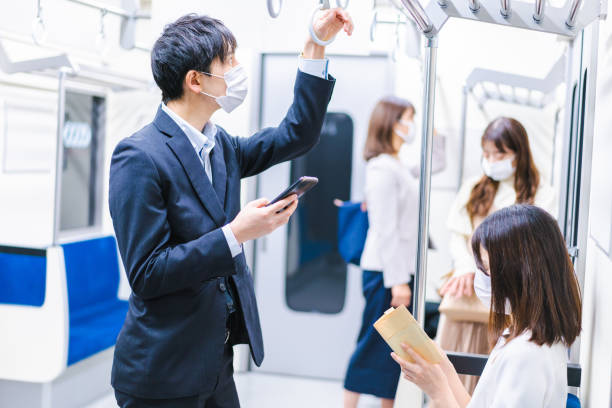istock People riding the train wearing masks 1367754100