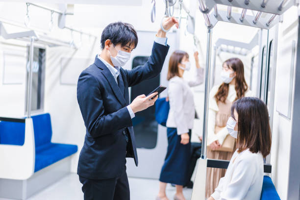 istock People riding the train wearing masks 1367754101
