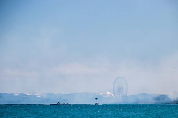 Fog covers Navy Pier in Chicago, IL with boat in distance Chicago, IL | USA: 8-22-2021 - Fog covers Navy Pier in Chicago, IL with boat in distance chicago smog stock pictures, royalty-free photos & images