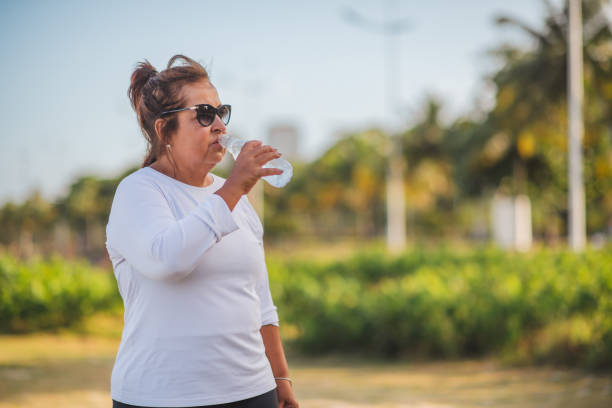 istock old woman walking outdoors 1367755834