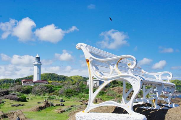 istock white bench on the cape with the lighthouse 1367757556