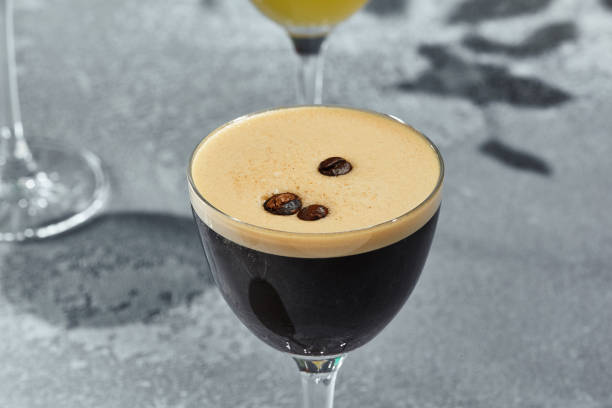 istock Coffee Sour Cocktail is a coffee liqueur based cocktail with white foam. Vintage table with sunshine and shadow. Strong alcohol drink topped with coffee seed. 1367758568
