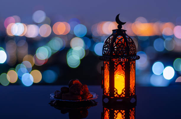 istock Lantern that have moon symbol on top and small plate of dates fruit 1367759486
