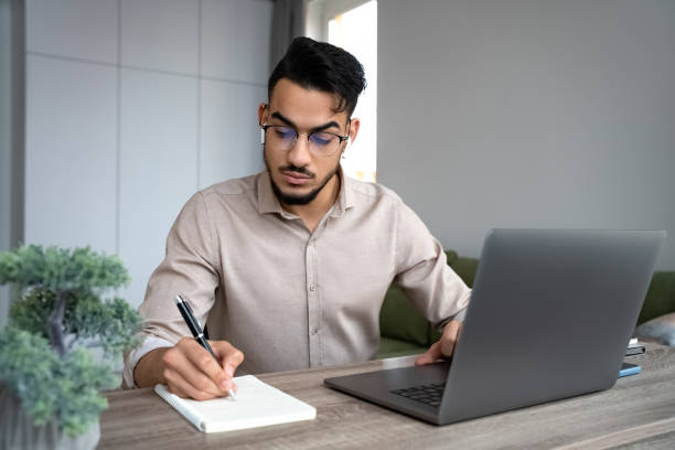 istock Young man student study on laptop in online college class from home office 1367760175