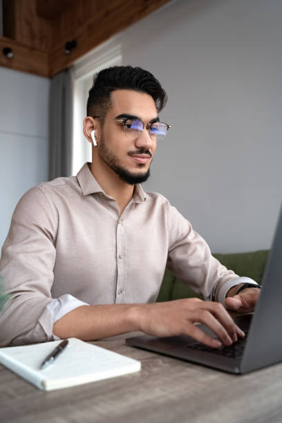 istock Happy young man student study or work online on laptop from home office 1367760257