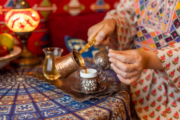Pouring turkish coffee from cezve into cup Pouring turkish coffee from cezve into cup turkish culture stock pictures, royalty-free photos & images