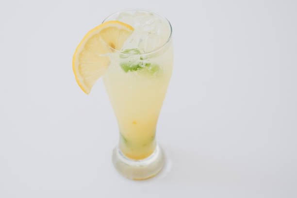 istock Glass lemon soda on white table. 1367762556