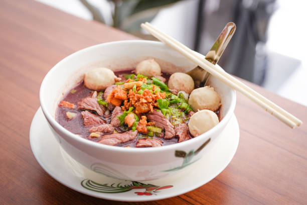 Pork Noodle soup on wooden table.