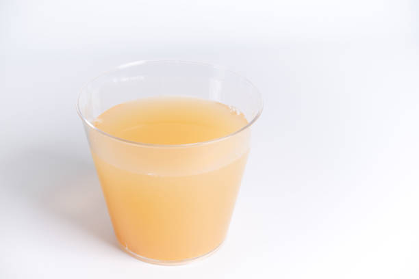 Apple juice in plastic cup, close up