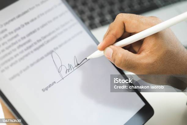 Close Up Businessman Hand Electronic Signature On Tablet By Stylus Write Business Agreement Of Contract Man Signing Contract On Tablet Business And Technology Concept Stock Photo - Download Image Now