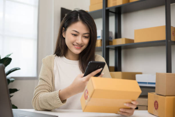 istock Startup Small business owner entrepreneur woman using smartphone scan qr code on product checking stock. Online business working at home. Contact customer on social network 1367763452
