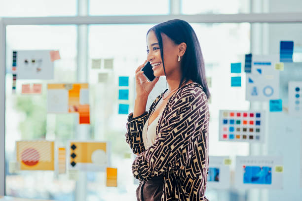 Shot of a young designer talking on a cellphone in an office