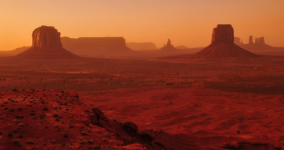 Windy and hazy sunset on the buttes and mesas of Monument Valley Navajo Tribal Park, Utah - Arizona border, USA