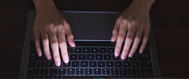 istock Close up of hand using computer and keyboard typing to the Internet online. 1367770356