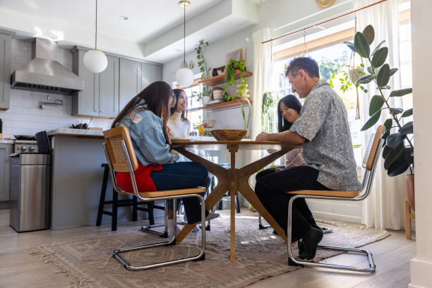 istock Diverse Mixed family praying before breakfast at the table. 1367773992