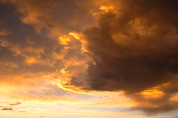 istock Beautiful sunset with golden orange clouds  background. Dramatic background. 1367777078
