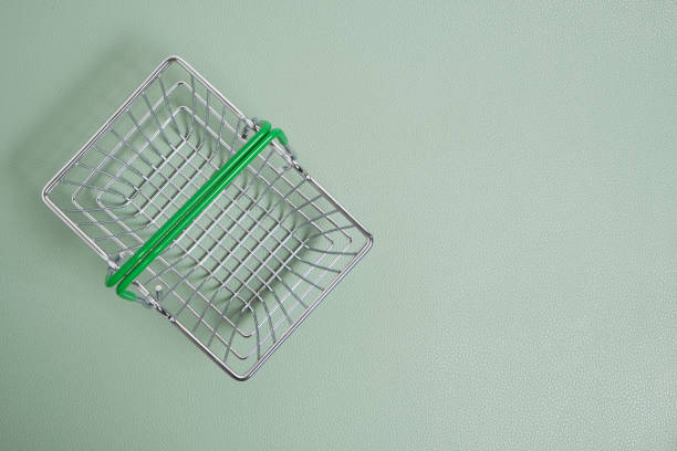 istock Shopping basket on a green background. 1367778520