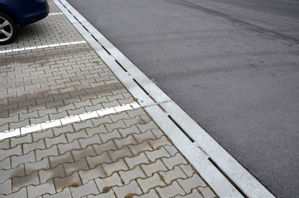 istock drainage element in interlocking paving concrete gutter with slotted drain from one piece of concrete can hold water from the parking lot along the entire length of the yard 1367778859