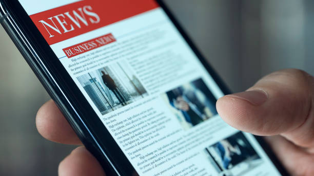 istock Reading news on mobile phone 1367779441