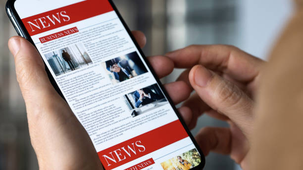 istock Reading news on mobile phone 1367779448