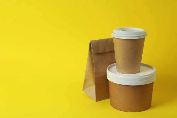 istock Delivery containers for takeaway food on yellow background 1367779594