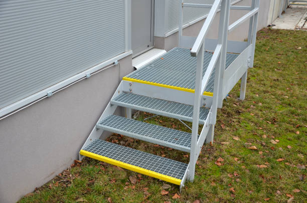 istock industrial hall, warehouse has a side door at a steep staircase with high resistance even under heavy load galvanized steel floor grate and railings. expanded metal, edges of stairs of safety yellow 1367779650