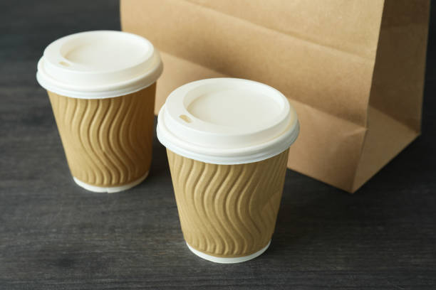 istock Paper cups and bag on dark wooden table 1367779779