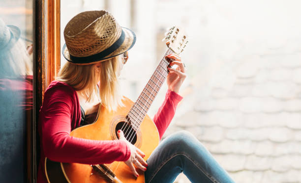 istock Young hipster woman plays guitar 1367779864