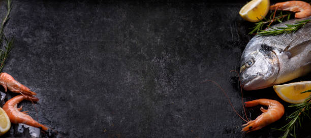 istock Sea food on black rustic background 1367780760
