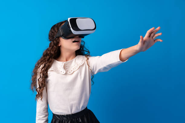 istock Girl with virtual reality glasses on blue background. 1367782561
