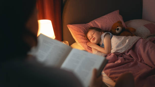 istock mother reading a book to her daughter 1367785508