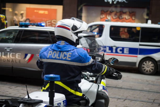 Portrait of french national policeman and motorbike in the street stock photo