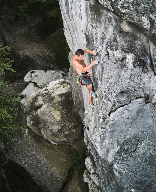 istock Male rock climber training rock climbing on a huge boulder 1367787627