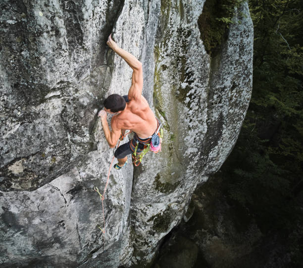 istock Male rock climber training rock climbing on a huge boulder 1367787629